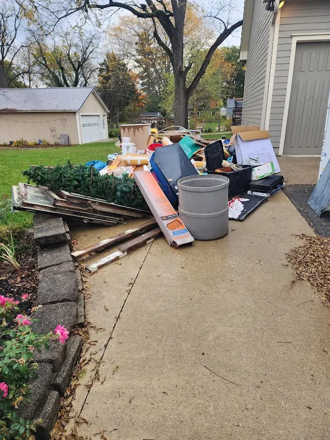 Dumpster being loaded with debris for Estate Cleanout Dumpster Rental in Benton